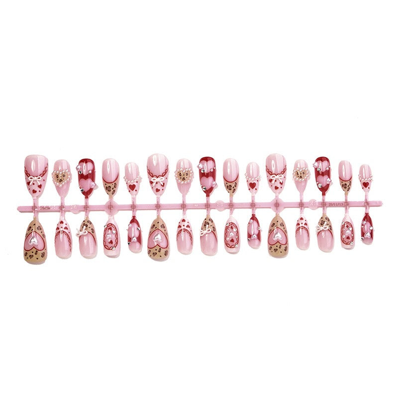 Artificial nail set with romantic heart designs and glamorous 3D details Kalsten