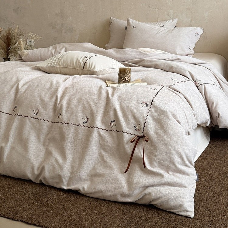 Embroidered bed linen set made of cotton-linen with delicate floral embroidery, wavy edge and ties.