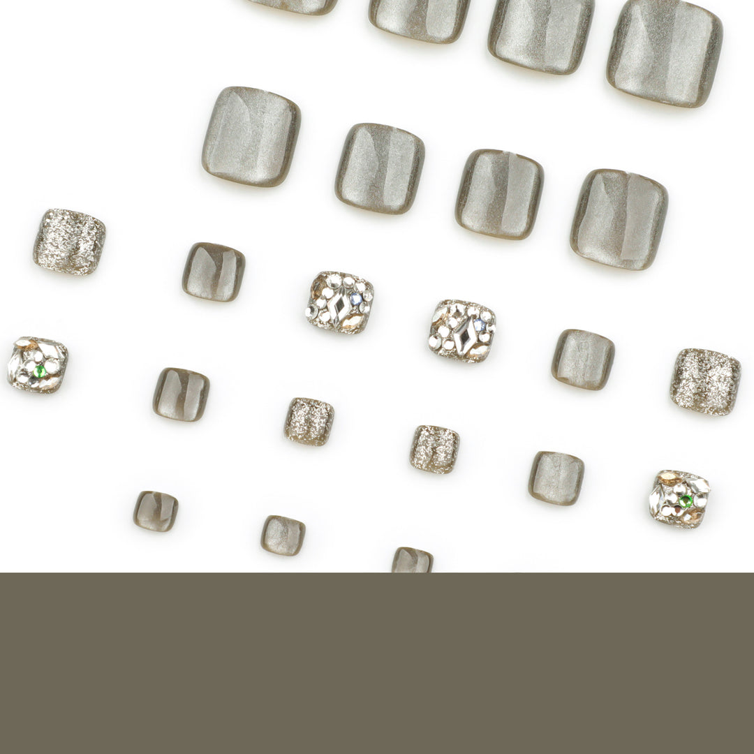 Artful toenail design with glitter and rhinestone decorations Kalsten