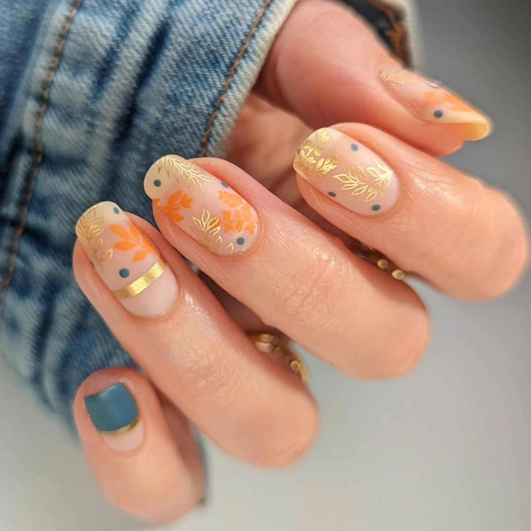 Artistic nail design with floral and golden accent Kalsten