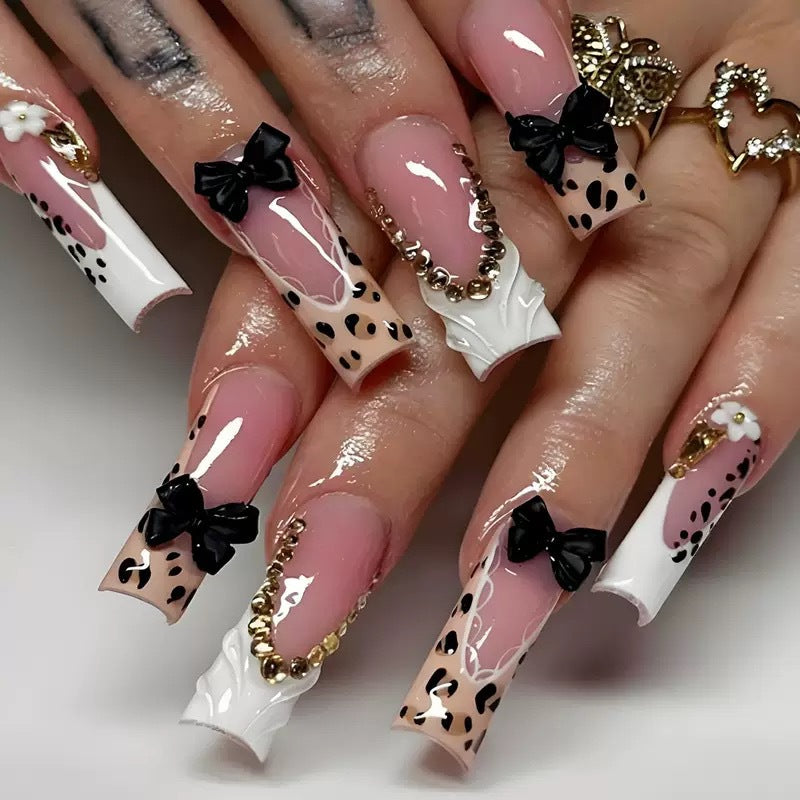 Artistic Press-On Nail Design with Bow and Animal Print Accents Kalsten