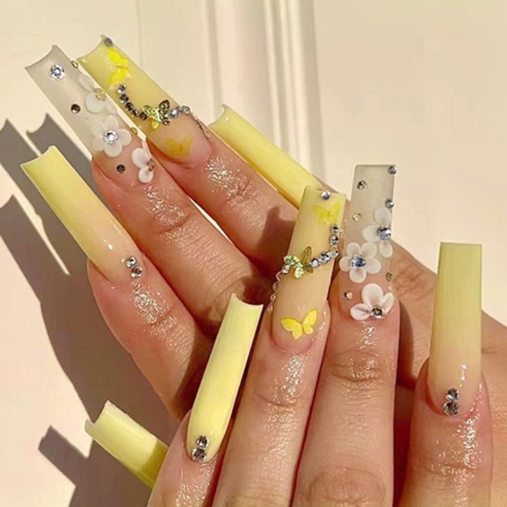 Artificial nail extensions with floral accents and rhinestones Kalsten