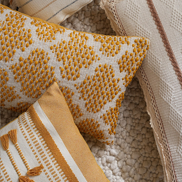 Structured square decorative pillow with crocheted trim and striped knit texture