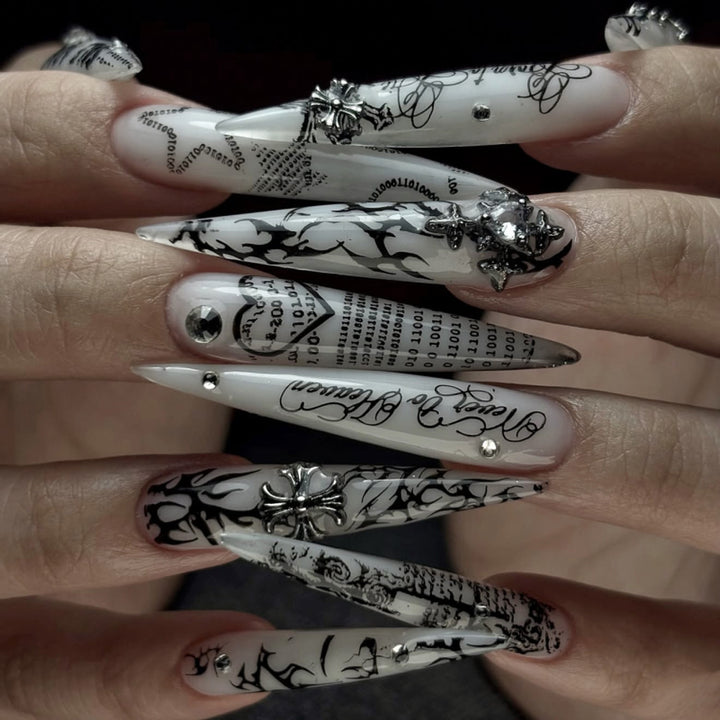 Artful stiletto nails with elegant floral design and glitter details Kalsten