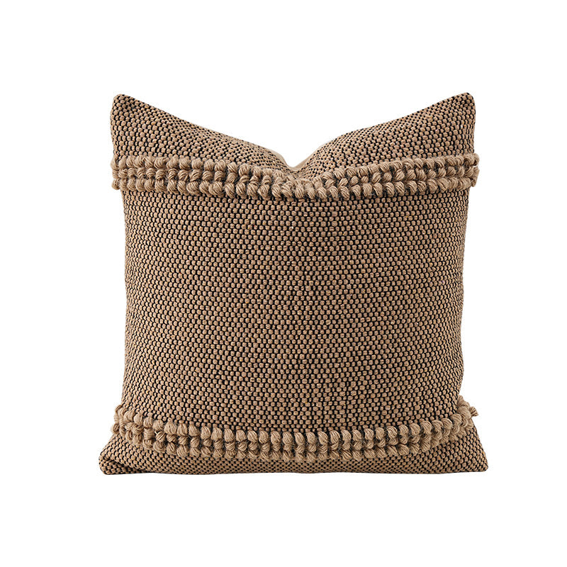 Square Boho decorative cushion made of coarsely woven cotton blend with decorative cord tufts