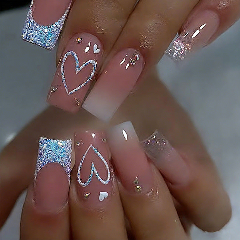 Artificial nails with sparkling heart designs and glitter details Kalsten