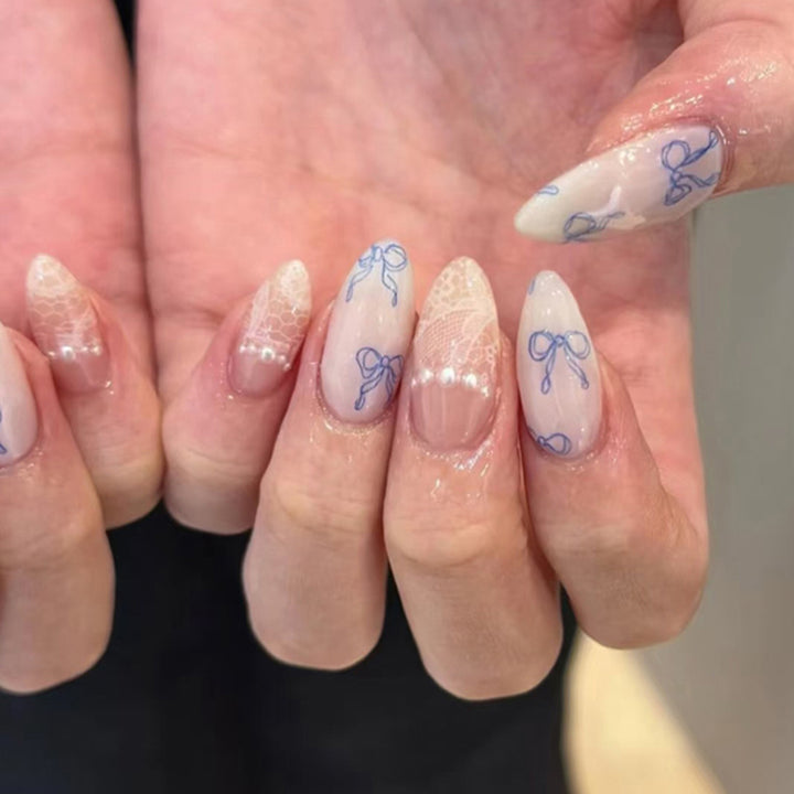 Artistic stiletto nails with delicate bow decorations Kalsten