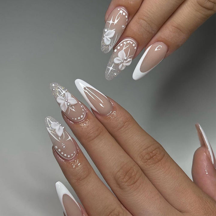 Artful stiletto nails with floral designs and glitter accents Kalsten