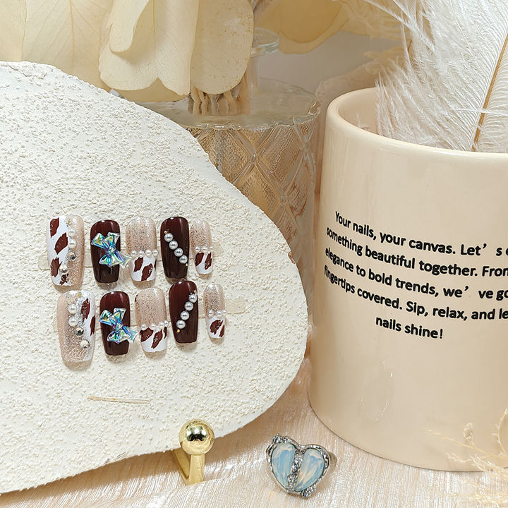 Artificial nails with glamorous rhinestone and bow design Kalsten