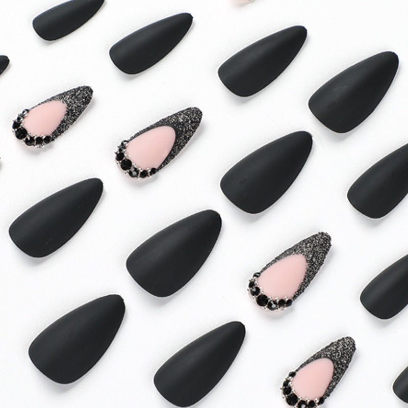 Artful stiletto nails with elegant black design and glitter accents Kalsten