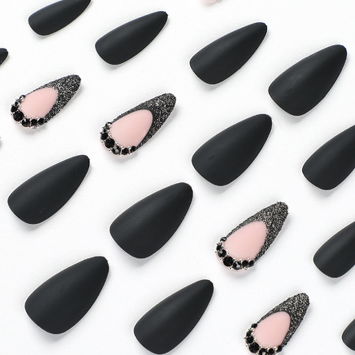 Artful stiletto nails with elegant black design and glitter accents Kalsten