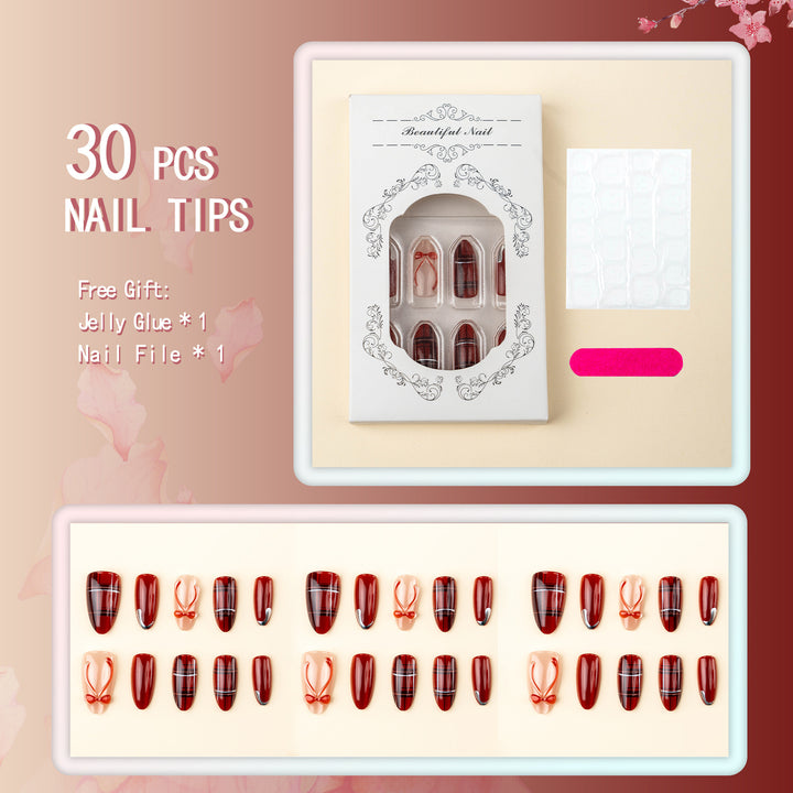 Art nail set with festive design and bow accents Kalsten