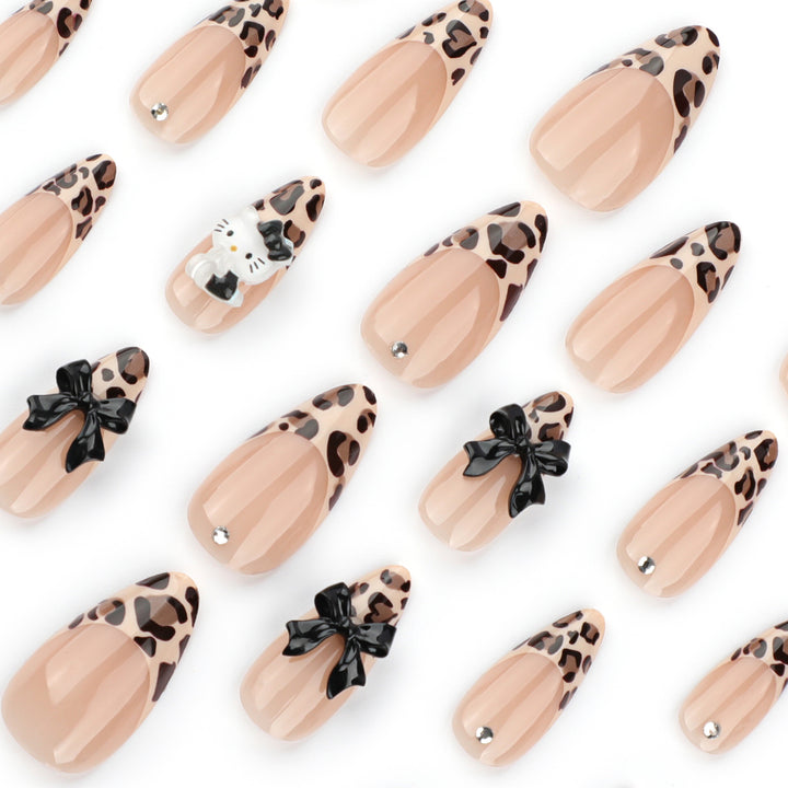Artistic extension nails in leopard pattern with bow accents Kalsten