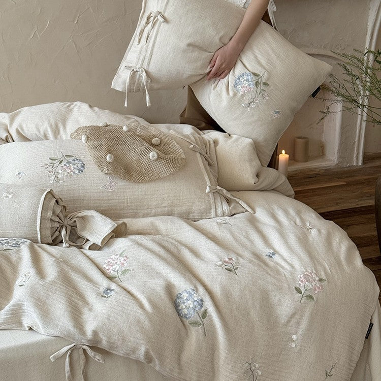 Embroidered cotton-linen bedding set with decorative ribbons and fine floral design