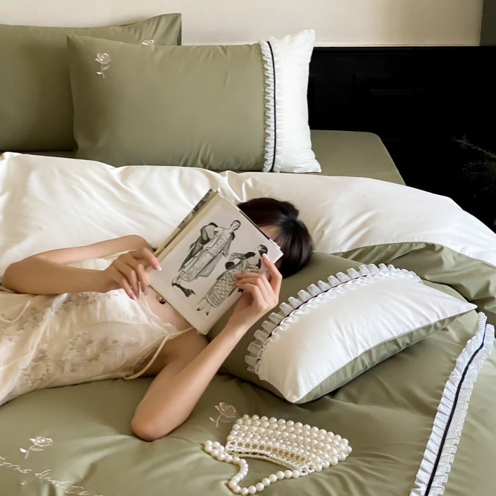 Cotton satin bed linen set with delicate rose embroidery, ruffled edge and contrasting reversible look