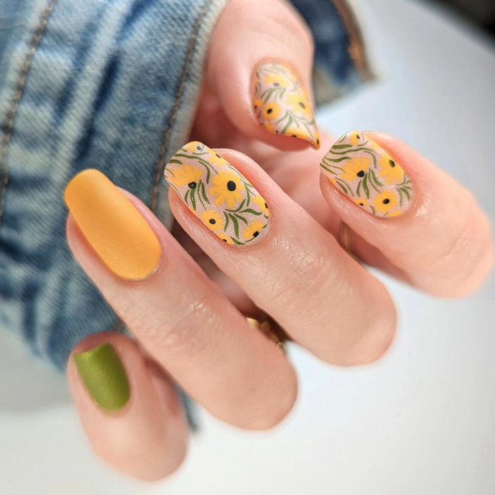Artistic nail extensions with floral designs and creative color accents Kalsten