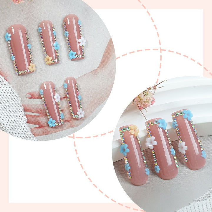 Artificial nail set with delicate flower embellishments and glitter accents Kalsten