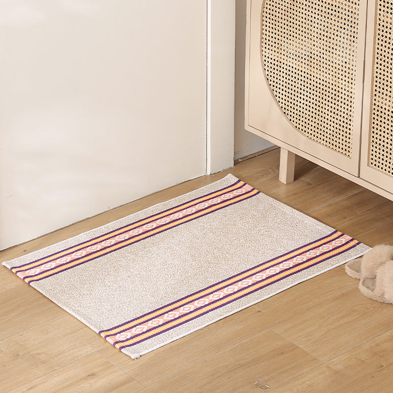 Striped cotton doormat with non-slip bottom and decorative woven edge Kalsten