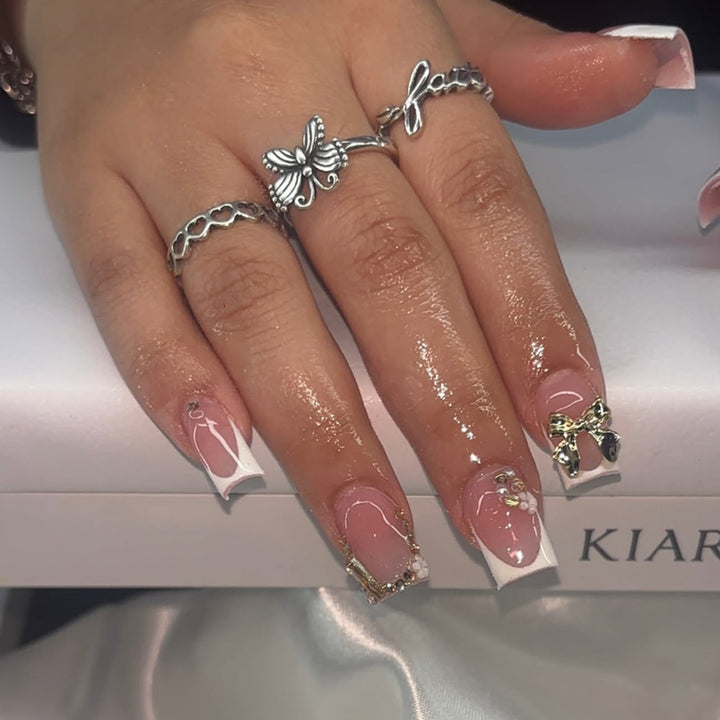 Elegant Nail Extensions with French Tips and Decorative Accents Kalsten