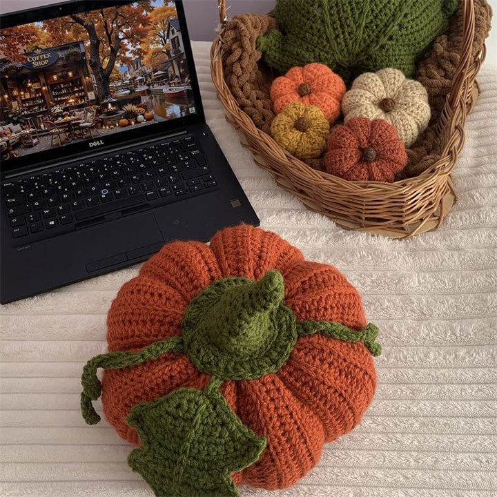 Hand-crocheted decorative cushion in pumpkin shape with leaf and vine application