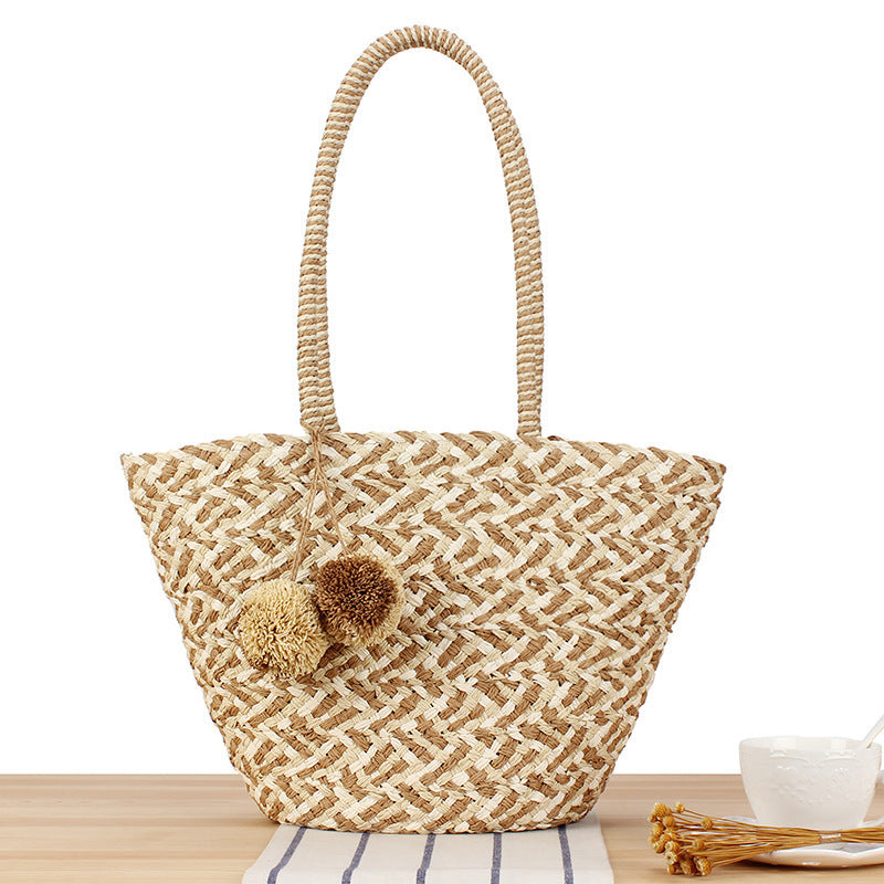 Fashionable basket bag with decorative pompons Kalsten