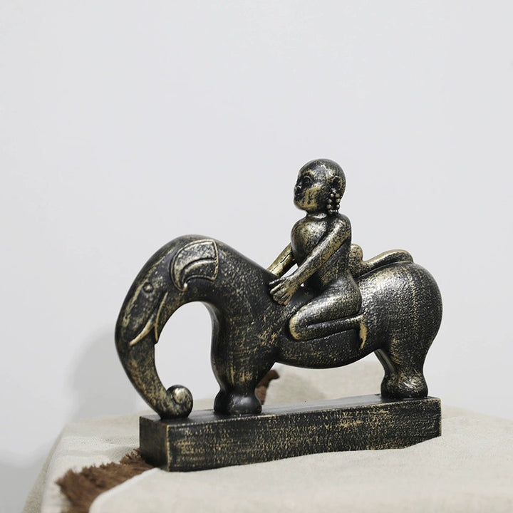 Whimsical Elephant and Child Sculpture