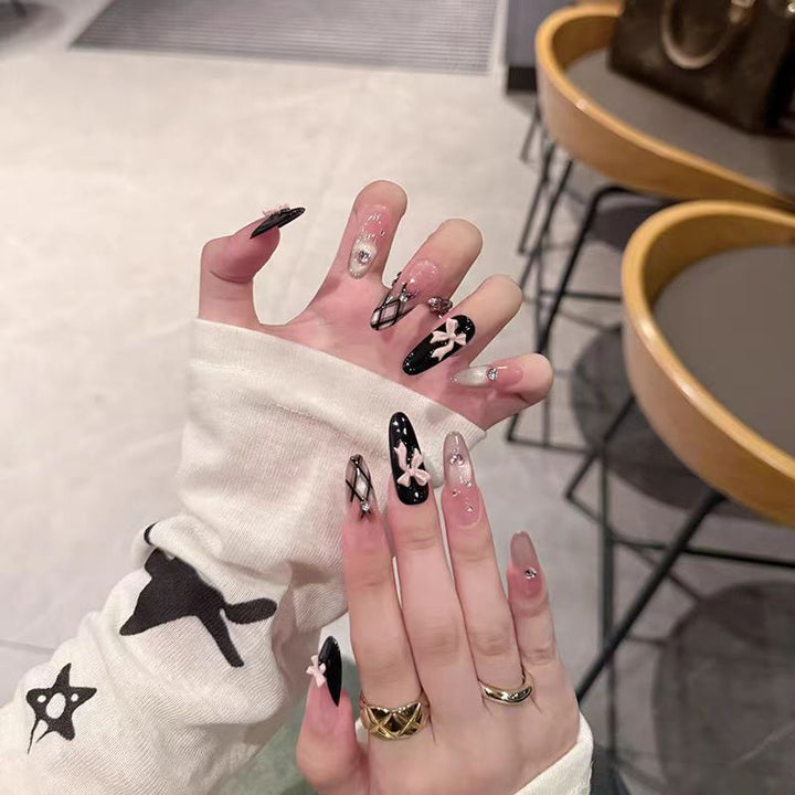 Artificial nails with playful bow design and glitter effects Kalsten
