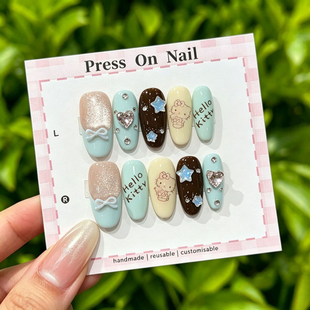 Artistic Press-On Nail Art Set with Cute Character and Bow Accents