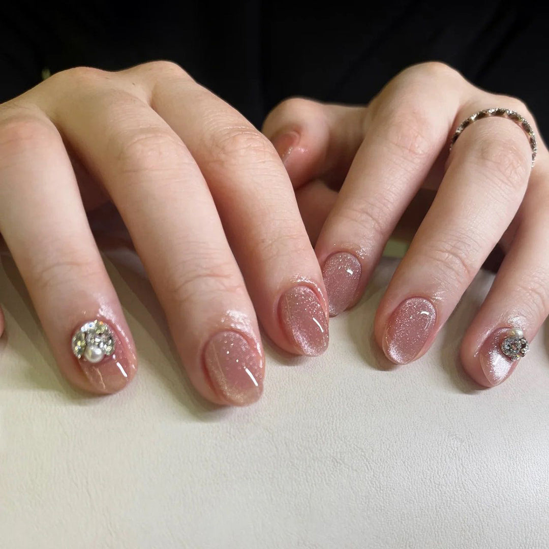 Artful glitter nail extensions with elegant rhinestone accents Kalsten