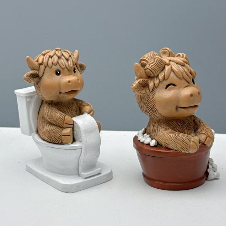 Funny decorative figure of a Highland cow on toilet Kalsten