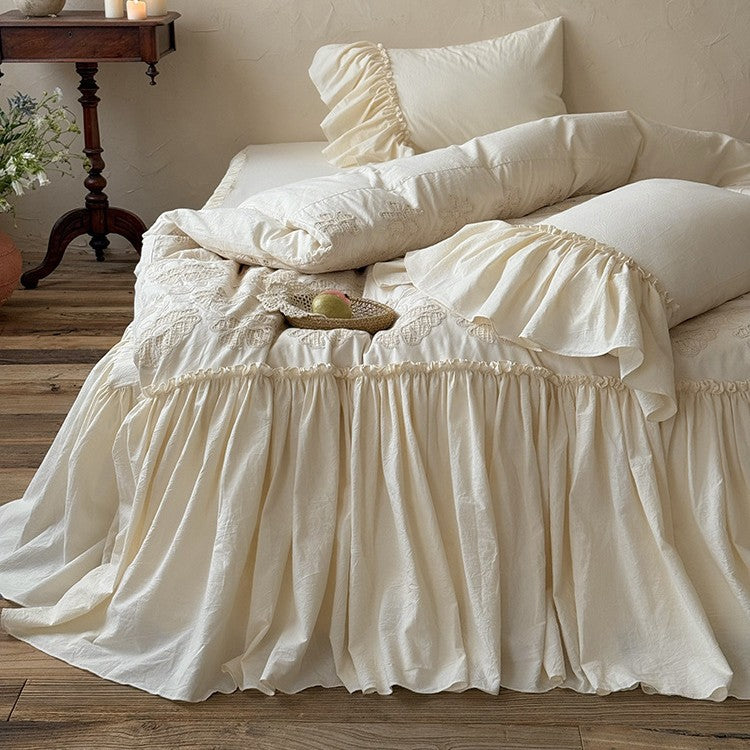 Vintage-inspired bed skirt and bedspread with wide ruffle and delicate embroidery