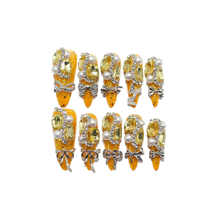 Glamorous artificial nails with rhinestones and pearl embellishments Kalsten