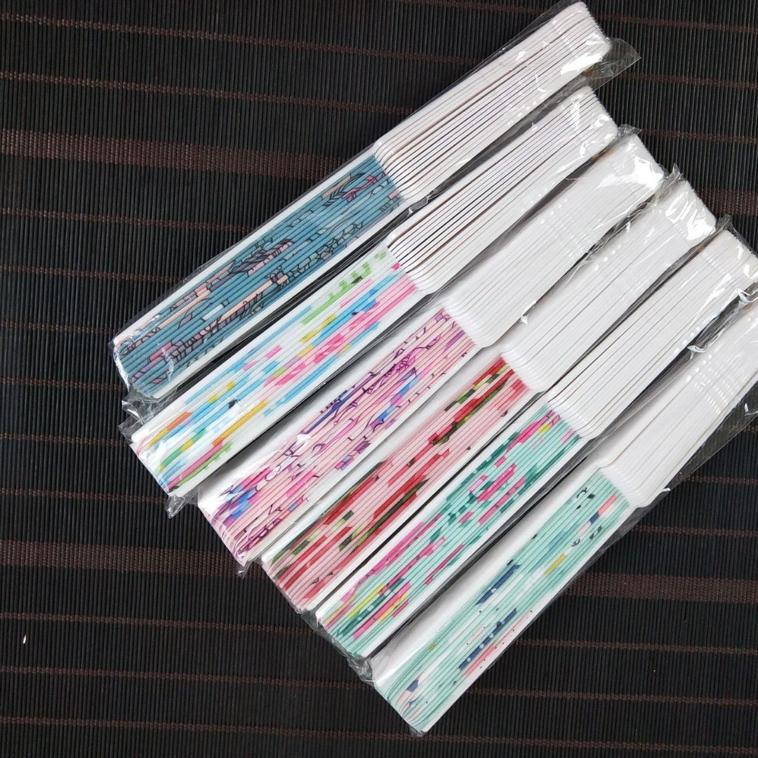 Women folding hand fan with shimmering scale pattern Kalsten