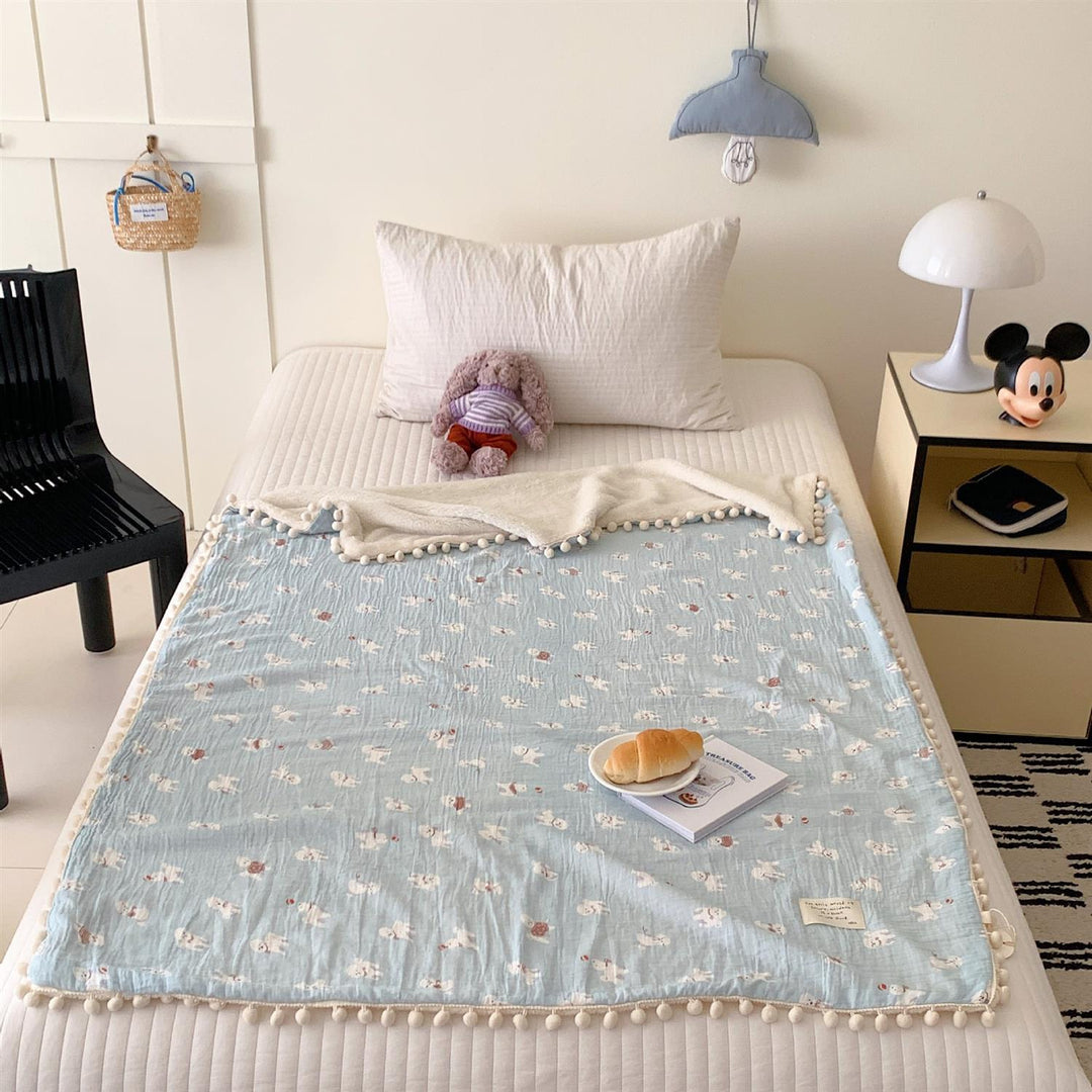 Children's Wende cuddly blanket made of cotton muslin with pompom border