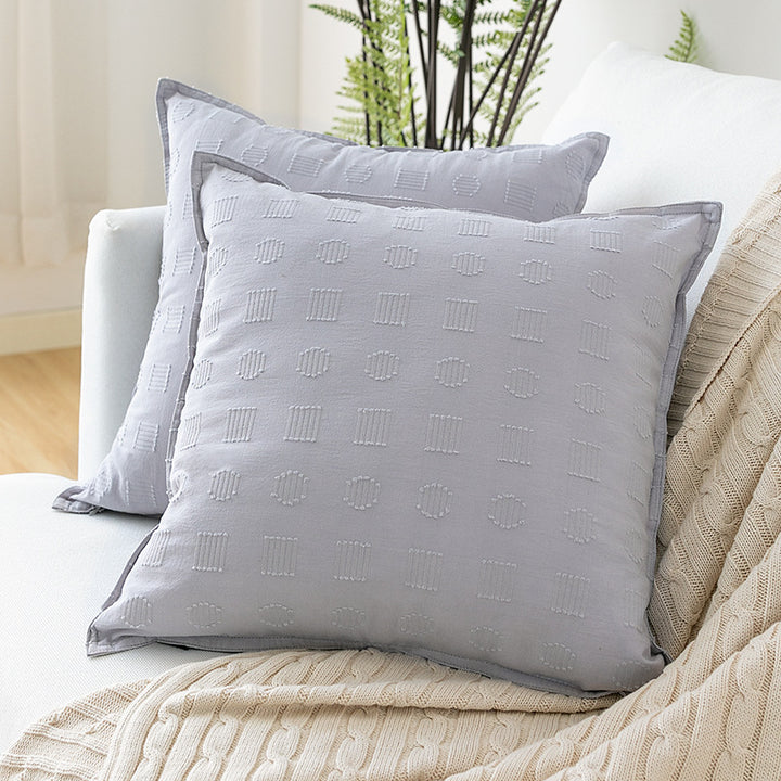 Square decorative cushion cover with subtle tufted geometric relief and piping