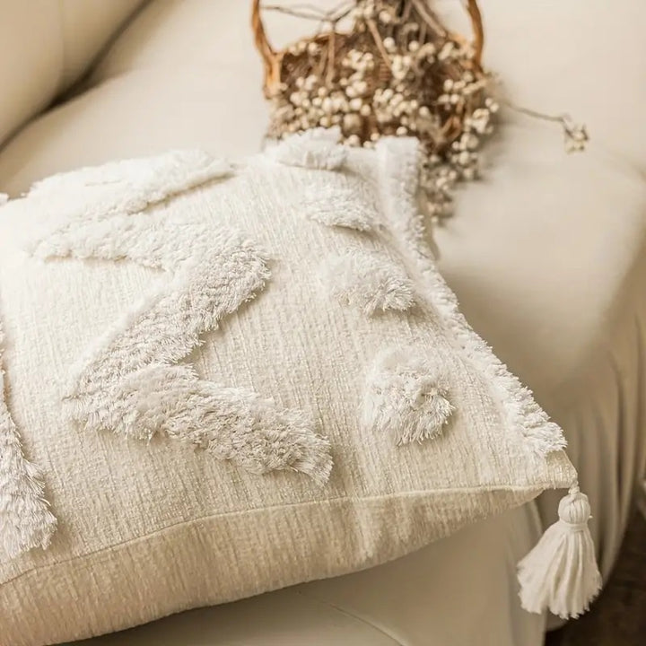 Rectangular decorative cushion cover with hand-tufted chevron and pompom relief as well as corner tassels Kalsten