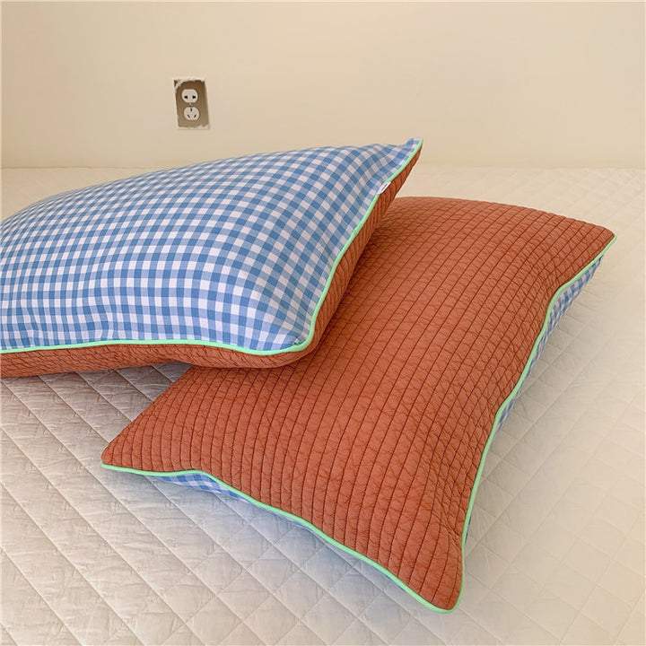 Reversible quilted pillow set with checked cotton cover and contrasting piping