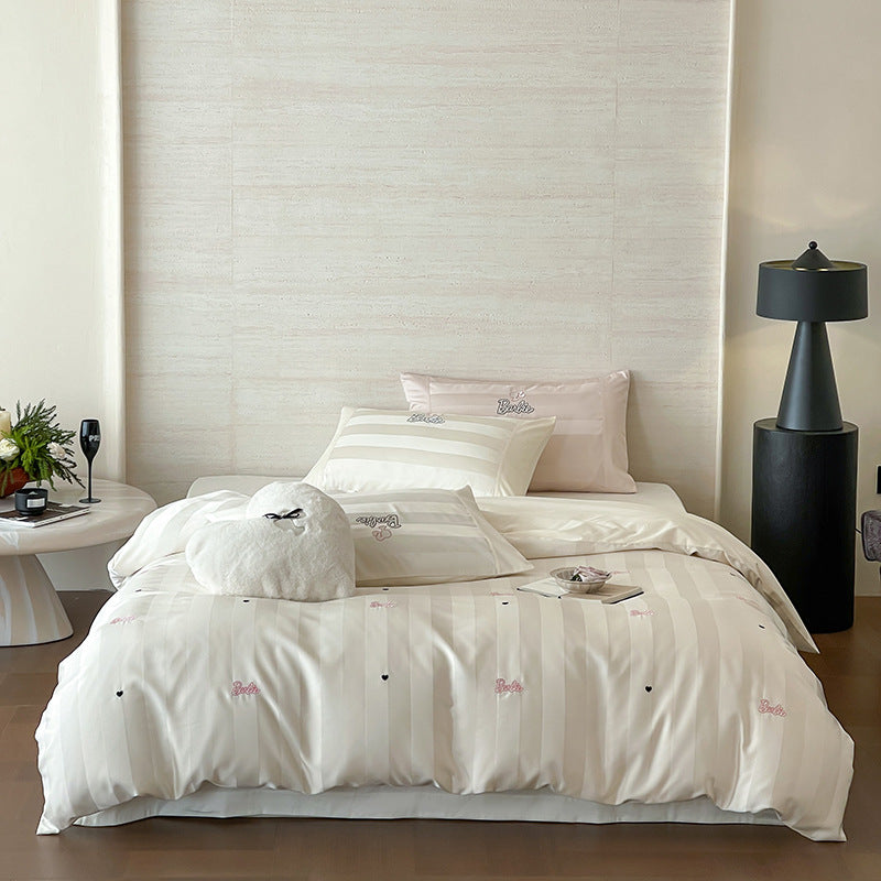 Luxurious cotton percale bedding set with fine striped jacquard look and embroidered lettering