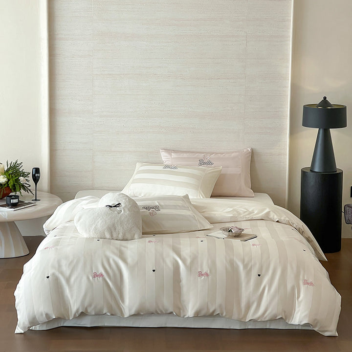 Luxurious cotton percale bedding set with fine striped jacquard look and embroidered lettering