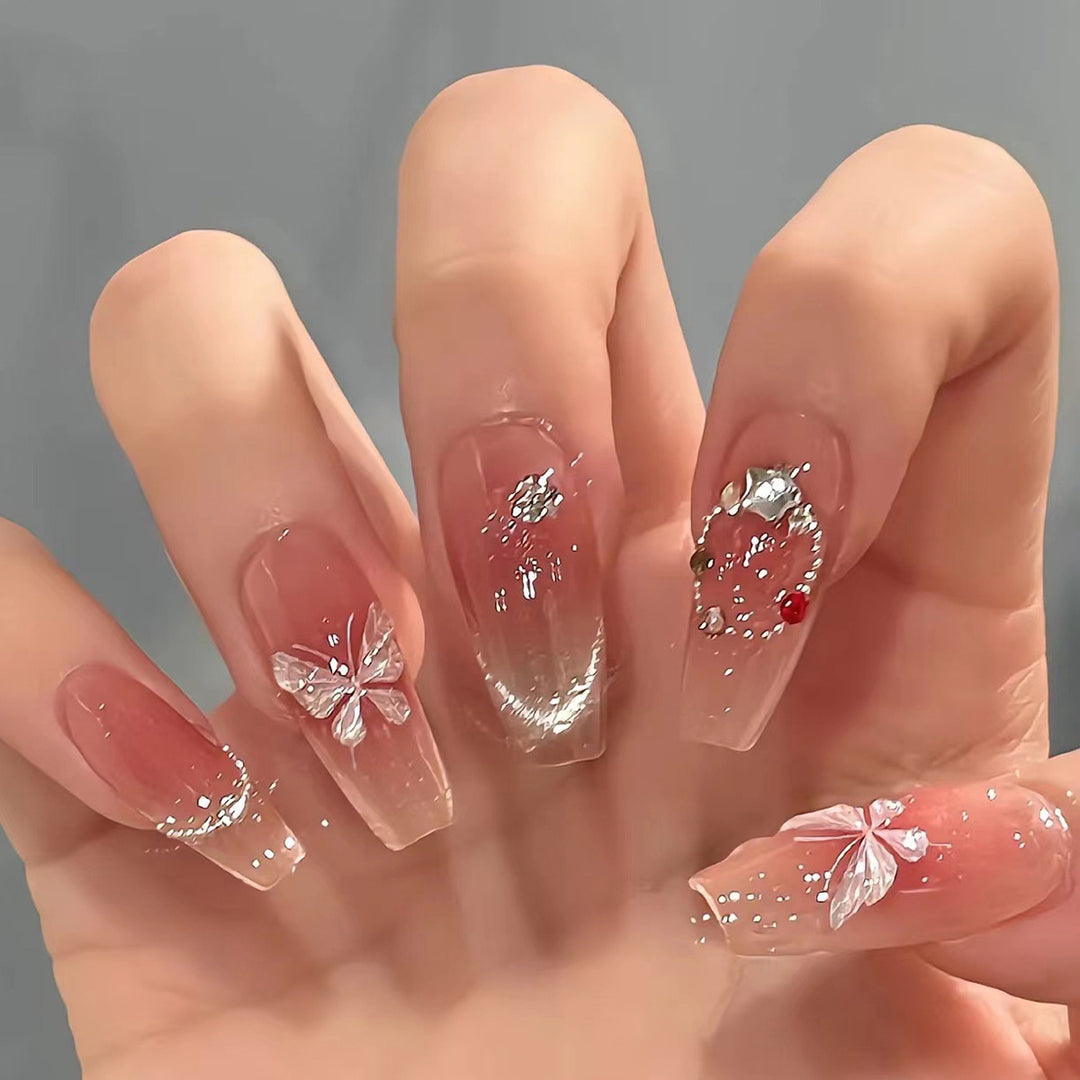 Artificial nail extensions with floral design and sparkling accents Kalsten