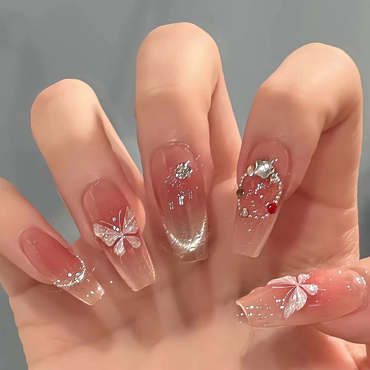 Artificial nail extensions with floral design and sparkling accents Kalsten
