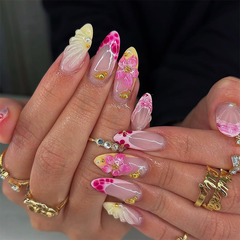 Artificial nails with floral accents and glitter decorations Kalsten