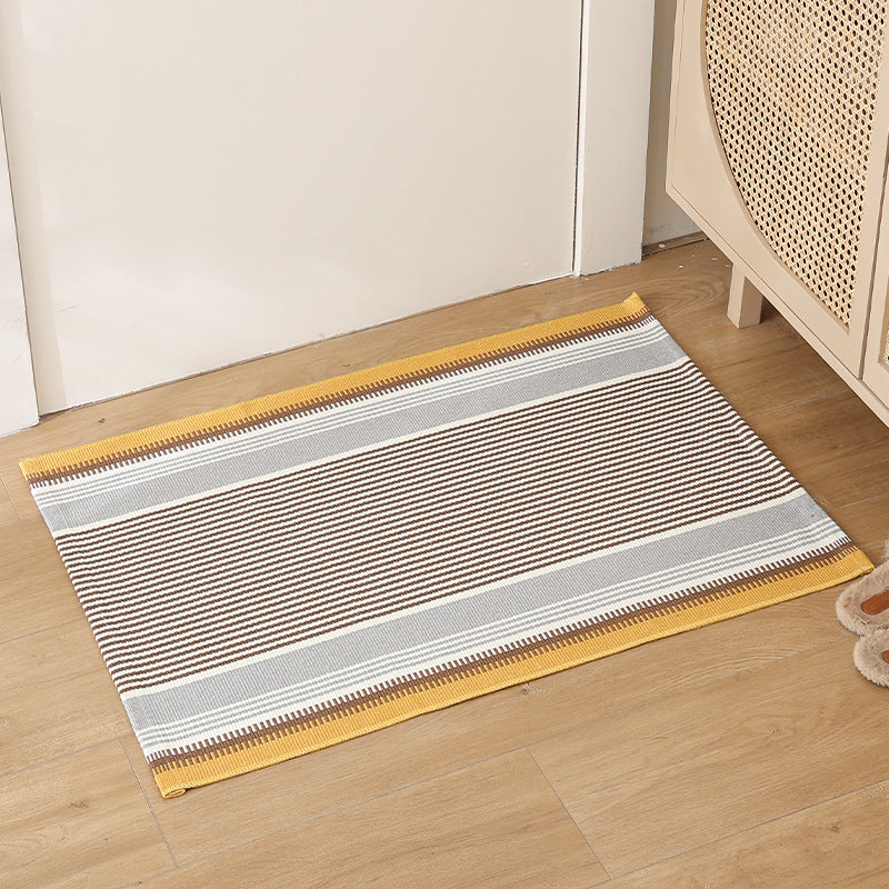 Striped cotton doormat with non-slip bottom and decorative woven edge Kalsten