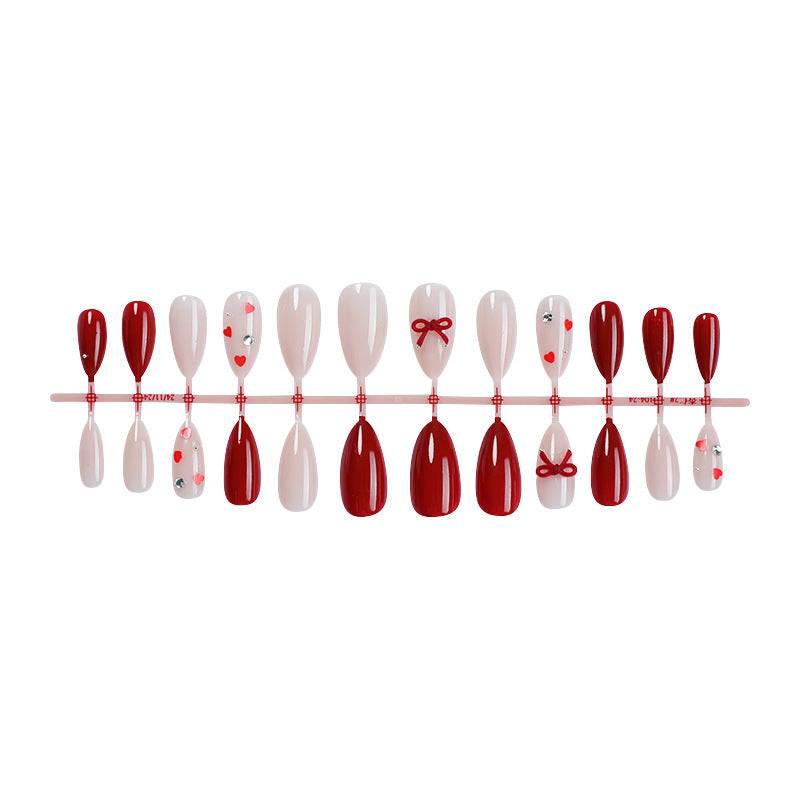 Artificial nail set with festive heart and bow accents Kalsten