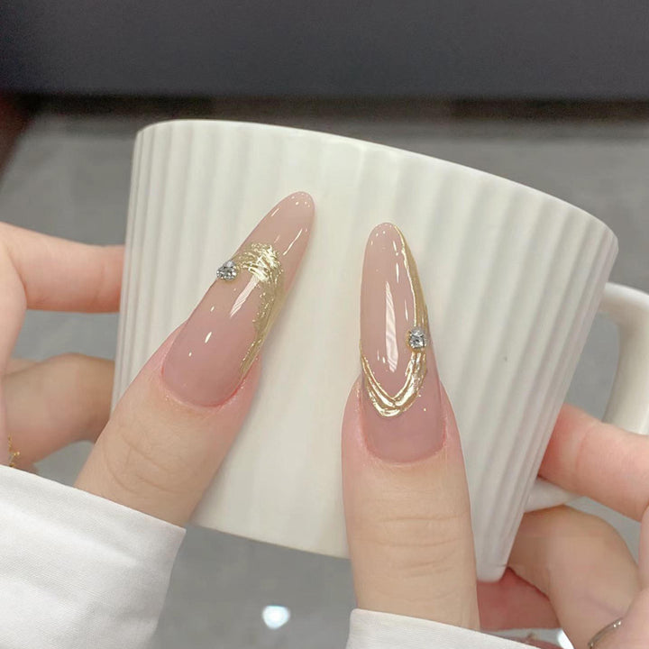 Artificial nail set with elegant gold design and sparkling applications Kalsten