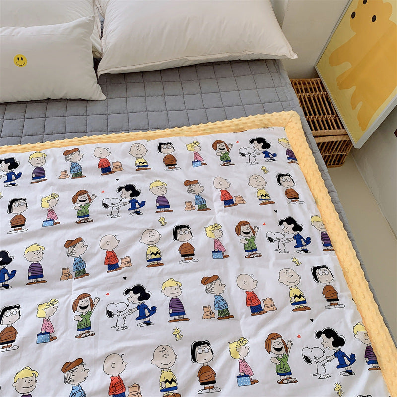 Children's quilt with colorful dinosaur print and soft minky border