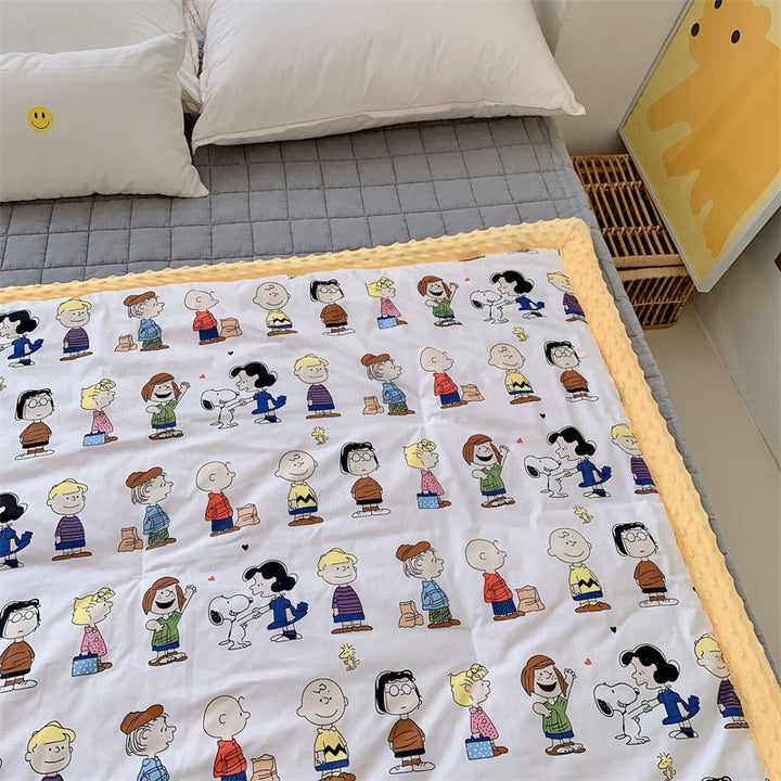 Children's quilt with colorful dinosaur print and soft minky border