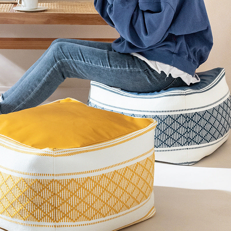 Woven seat pouf with quilted synthetic leather top and carry handle
