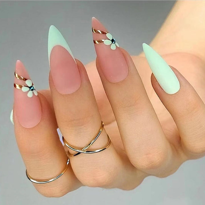 Artistic stiletto nails with floral accents and glitter embellishments Kalsten