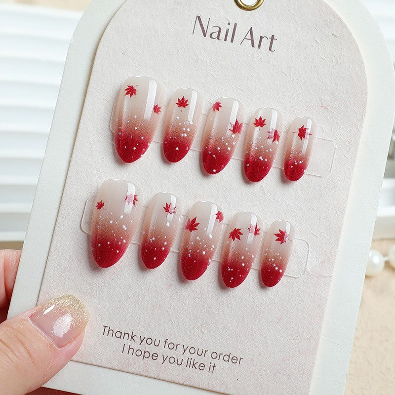 Art nail set with elegant red ombré look and delicate maple leaves Kalsten